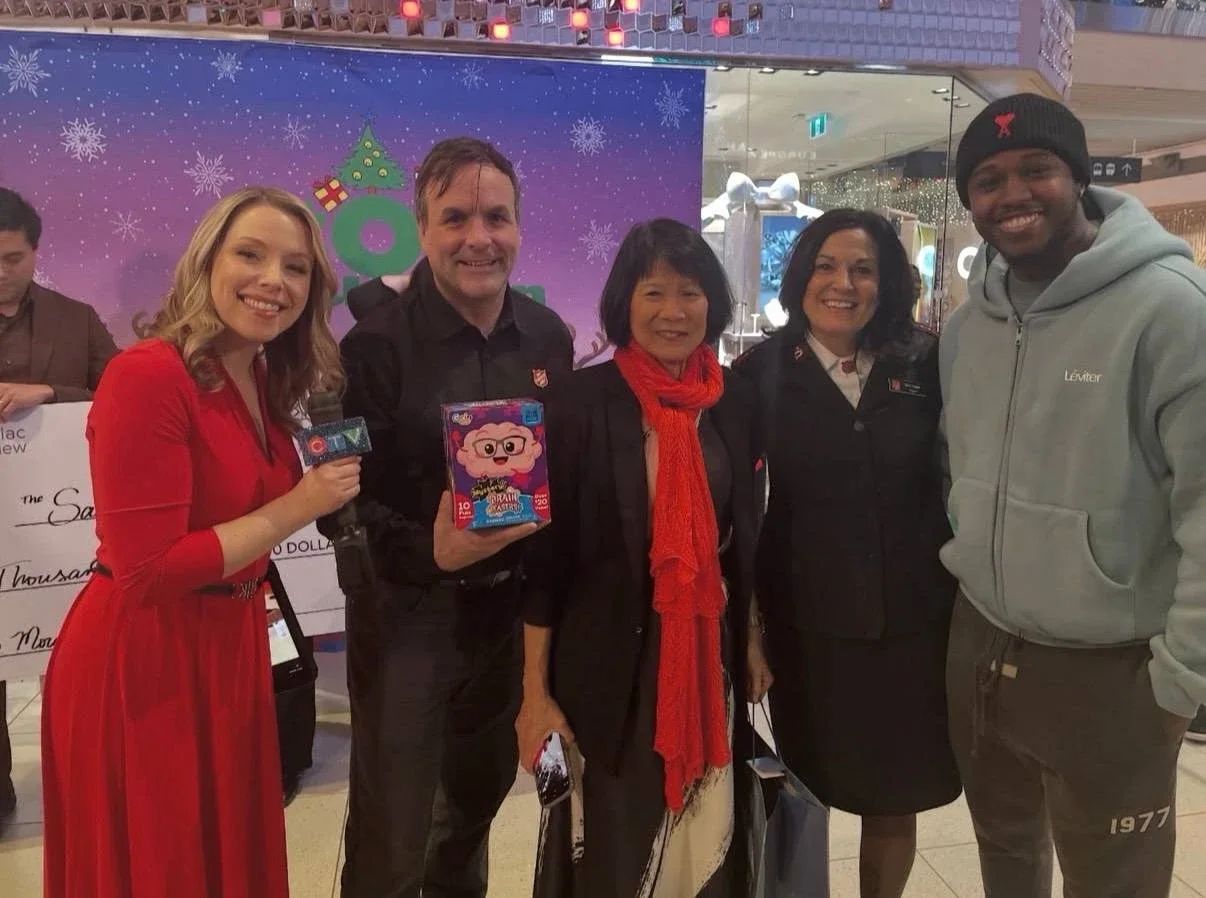 A WLTH member with CTV and The Salvation Army at a Toy Mountain donation